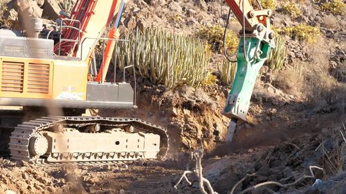 Photo of heavy machinery digging through nature